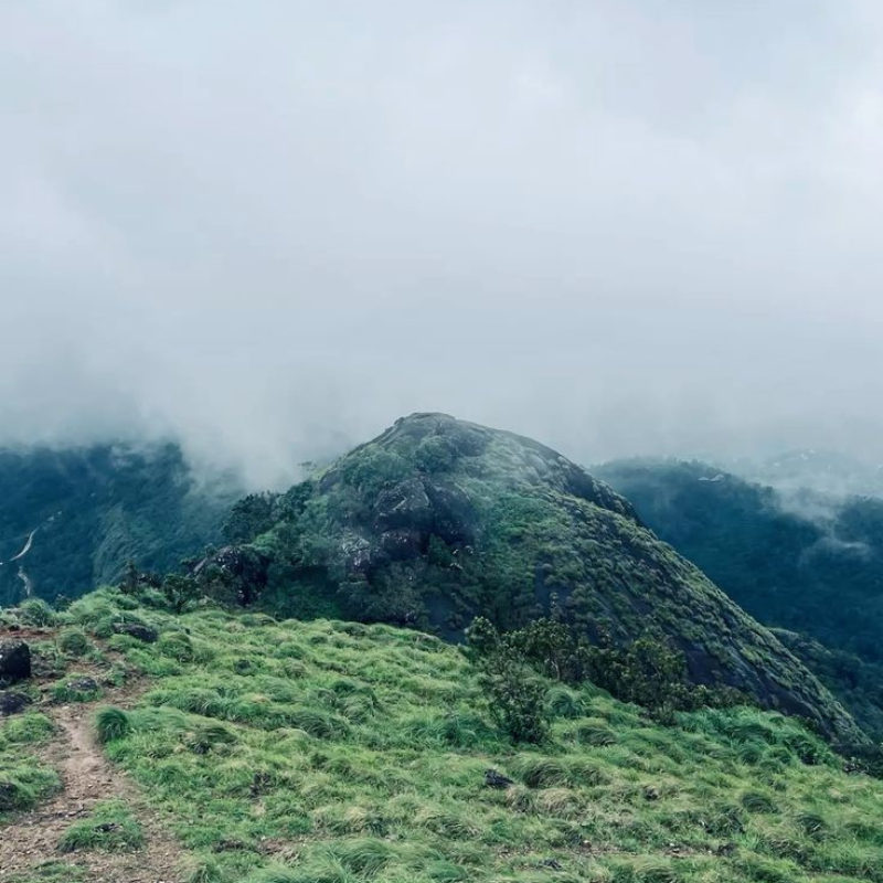Panoramic misty mountain view from Kakkadampoyil hill station