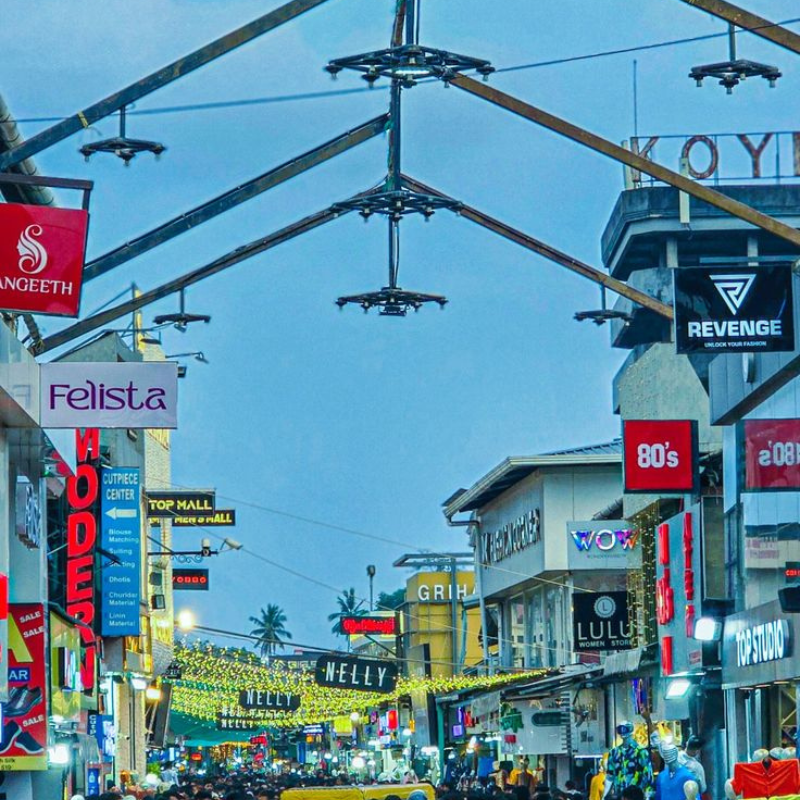 Bustling crowd and colorful shops on Sweet Meat Street Kozhikode