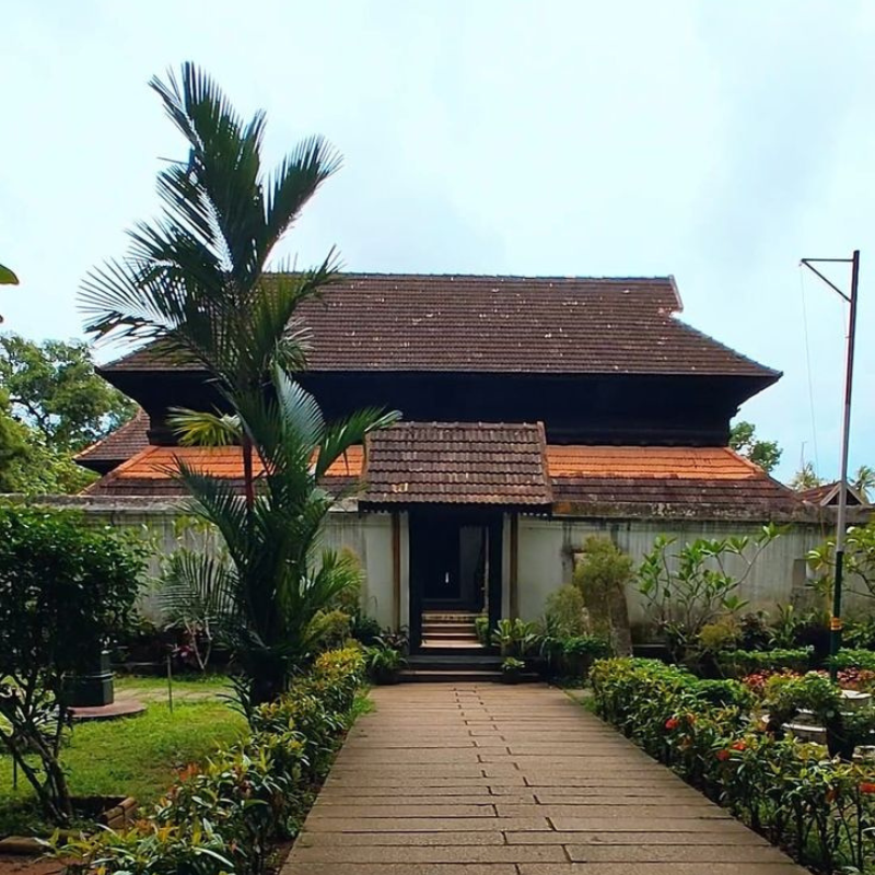 Exterior of Krishnapuram Palace showing gabled roofs and Kerala murals