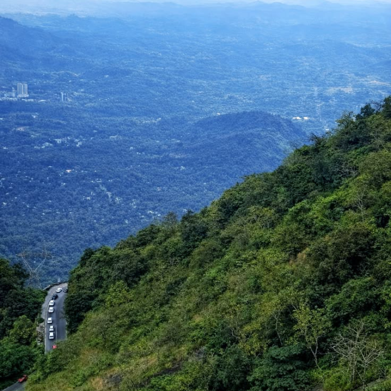 Panoramic view of the winding roads and misty mountain valleys at Lakkidi.