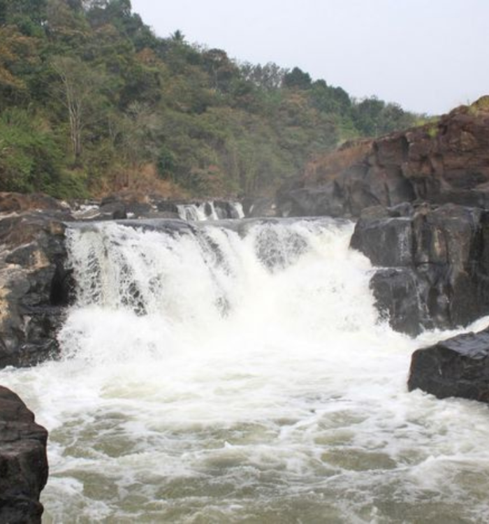 Wide panoramic view of Perunthenaruvi rocky waterfall