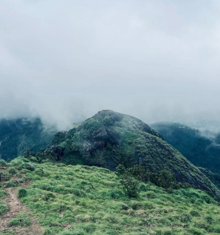 Panoramic misty mountain view from Kakkadampoyil hill station
