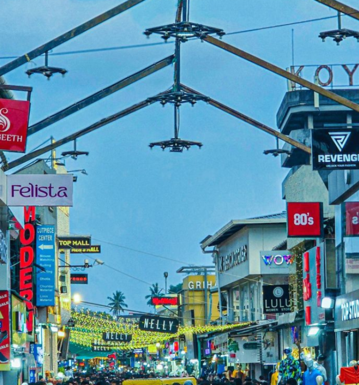 Bustling crowd and colorful shops on Sweet Meat Street Kozhikode