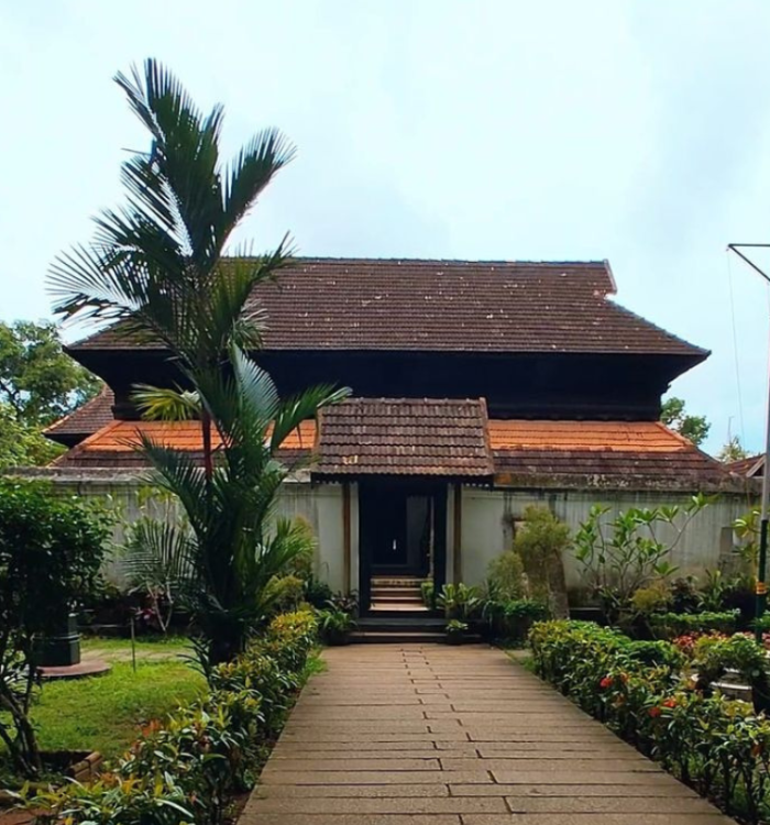 Exterior of Krishnapuram Palace showing gabled roofs and Kerala murals