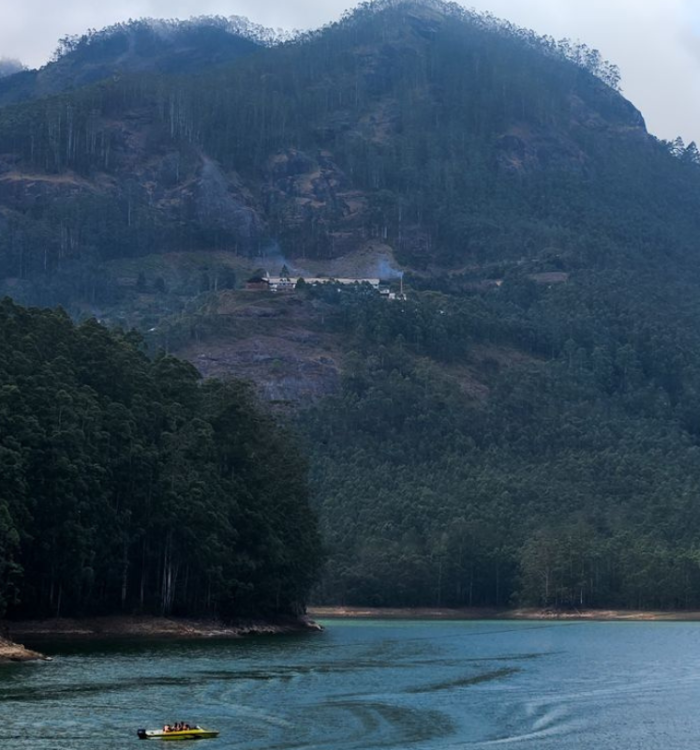 Speedboats on the water with mountain reflections at Mattupetty Dam