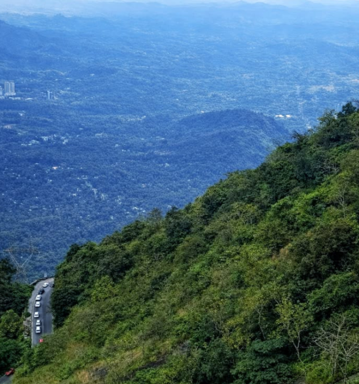 Panoramic view of the winding roads and misty mountain valleys at Lakkidi.